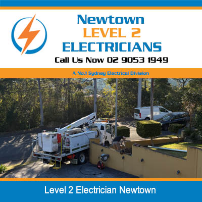 Electrical service trucks of level 2 electrician at residential worksite in Newtown