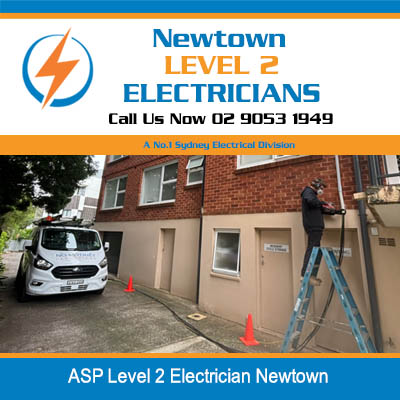 ASP level 2 electrician on ladder working at residential property with service van parked in Newtown